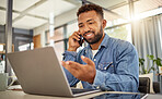 Remote entrepreneur working from home on his laptop. Virtual businessman making a phone call on his cellphone. Confident businessman telework from home. Freelance businessman talking during phone call