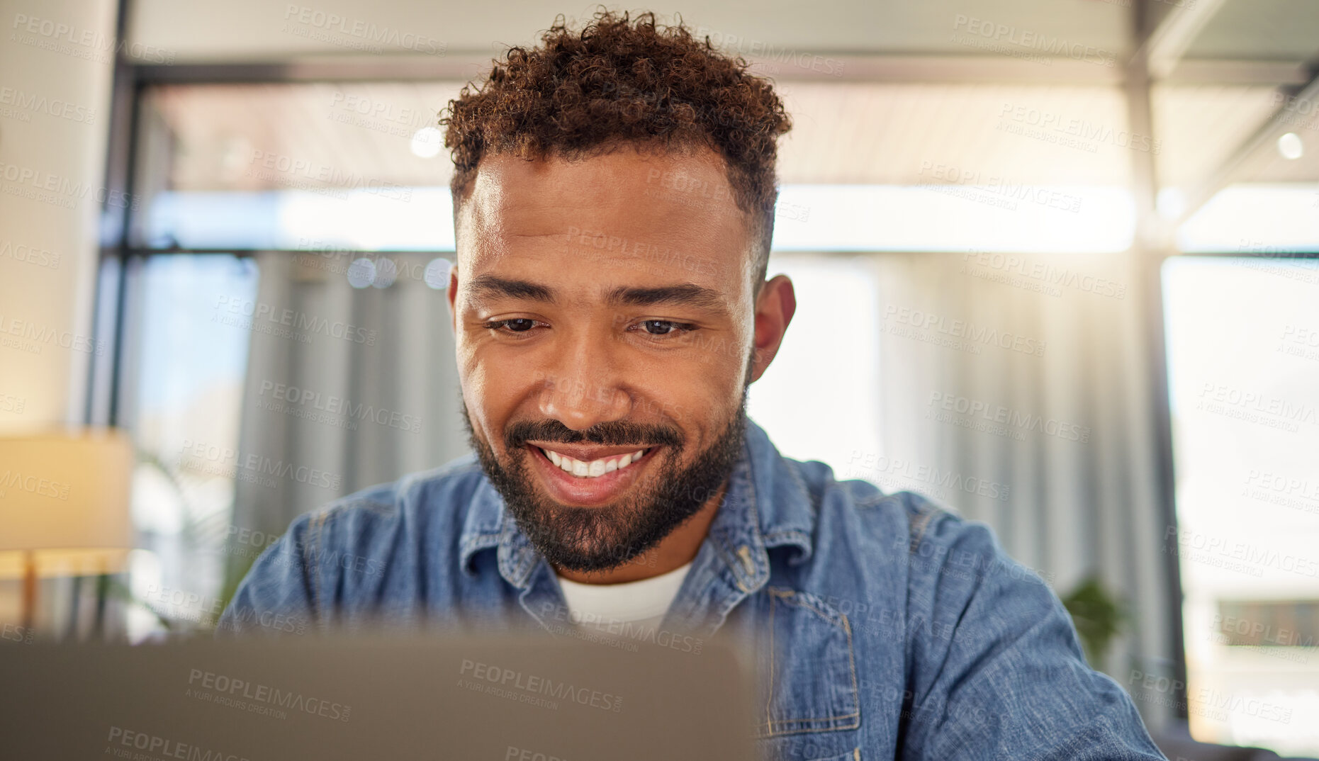 Buy stock photo Happy businessman online on his laptop. Young entrepreneur using his laptop at home. Freelance virtual worker planning on his computer at home. Businessman using a wireless digital device.