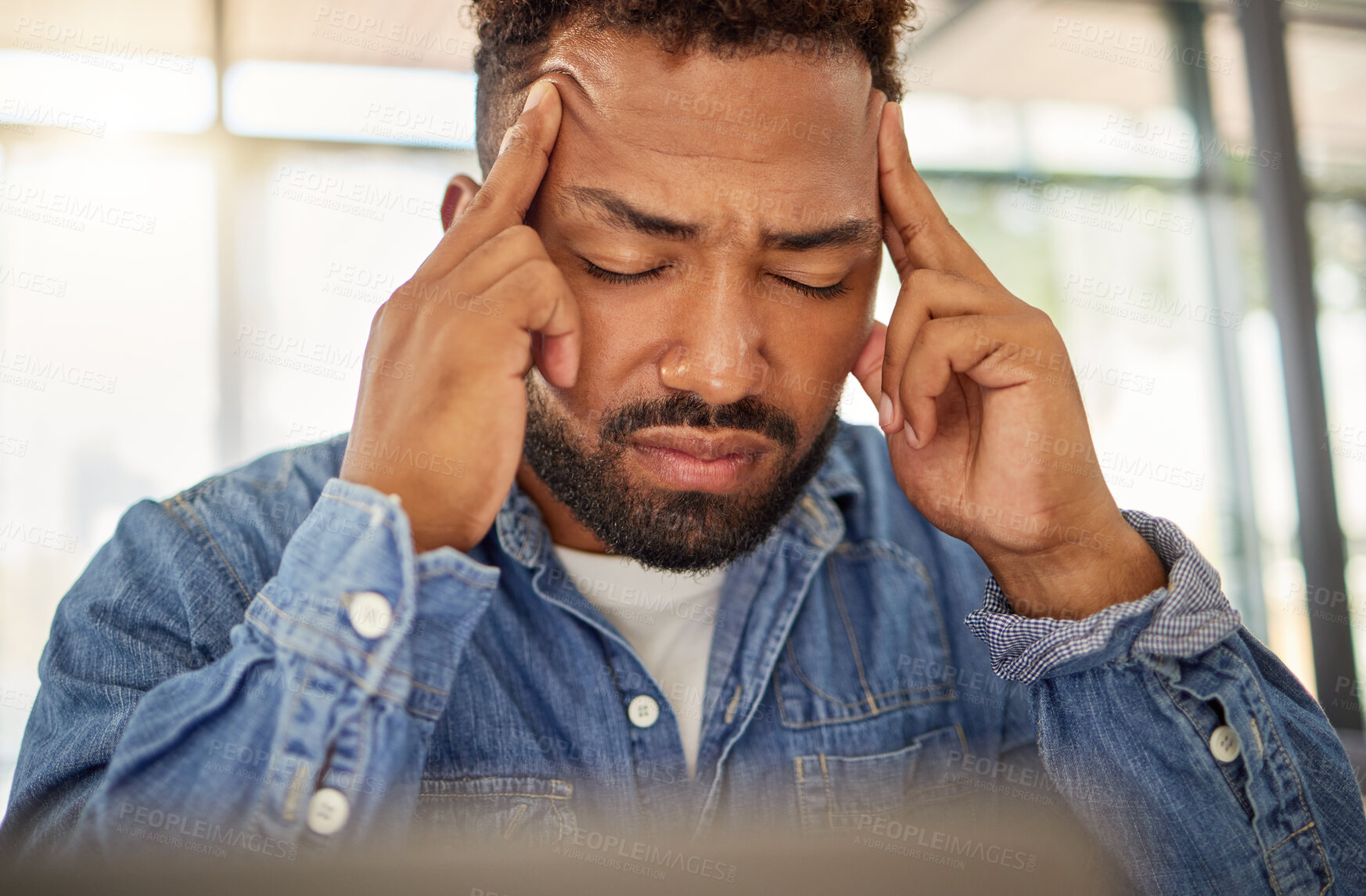 Buy stock photo Young man looking stressed with a headache at home. Man feeling anxious with a migraine at home. Depressed young man with a headache at home. bachelor having a breakdown crisis at home