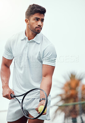Buy stock photo Serious indian tennis player getting ready to serve on court alone. One ethnic fit athlete holding a racket and ball during match. Focused active and healthy man playing game as exercise and training