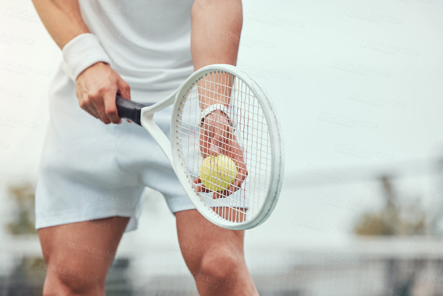 Buy stock photo Closeup of unknown mixed race tennis player getting ready to serve on court. Hispanic fit athlete holding racket and a ball during match. Active and healthy man playing a game as exercise and training