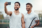 Portrait of two smiling ethnic tennis players taking selfie on cellphone after playing court game. Happy ethnic athletes team bonding, taking picture on phone. Friends play sports for healthy fitness
