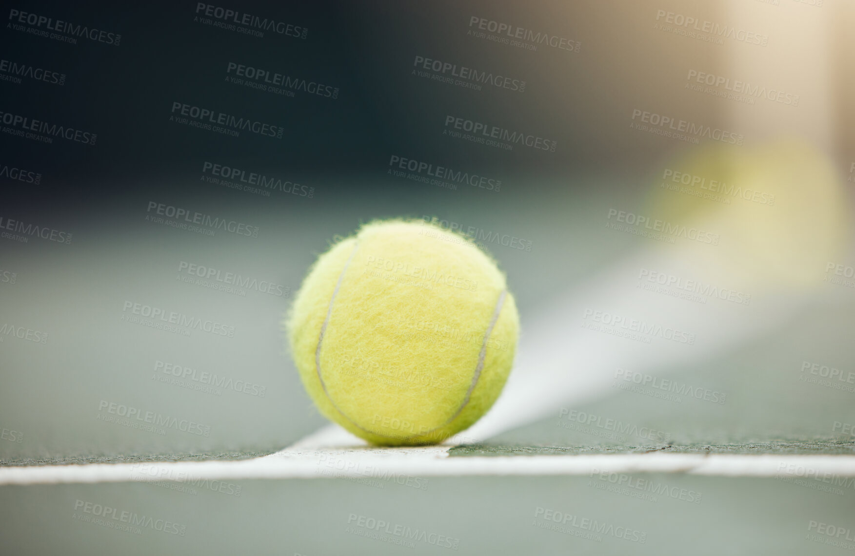 Buy stock photo Closeup of one yellow tennis ball on the floor during a game on a court. Macro still life ball on white line during a competitive sports match in a sports club. Losing and out by touching the marking