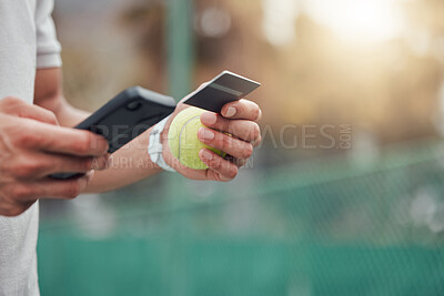 Closeup of unknown mixed race tennis player using cellphone and credit card on court. Hispanic fit athlete paying for sports membership on a phone in club. Active healthy man buying renew subscription