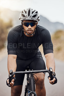 Buy stock photo One athletic young man cycling outside. Sporty fit male wearing helmet and glasses while riding a bike on a road along the mountain for exercise. Endurance and cardio during a workout and training