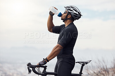 Buy stock photo Sports man with a bike drinking water bottle doing fitness training or workout on sky mockup background. Healthy, professional athlete cyclist with a bicycle during cycling cardio exercise in nature