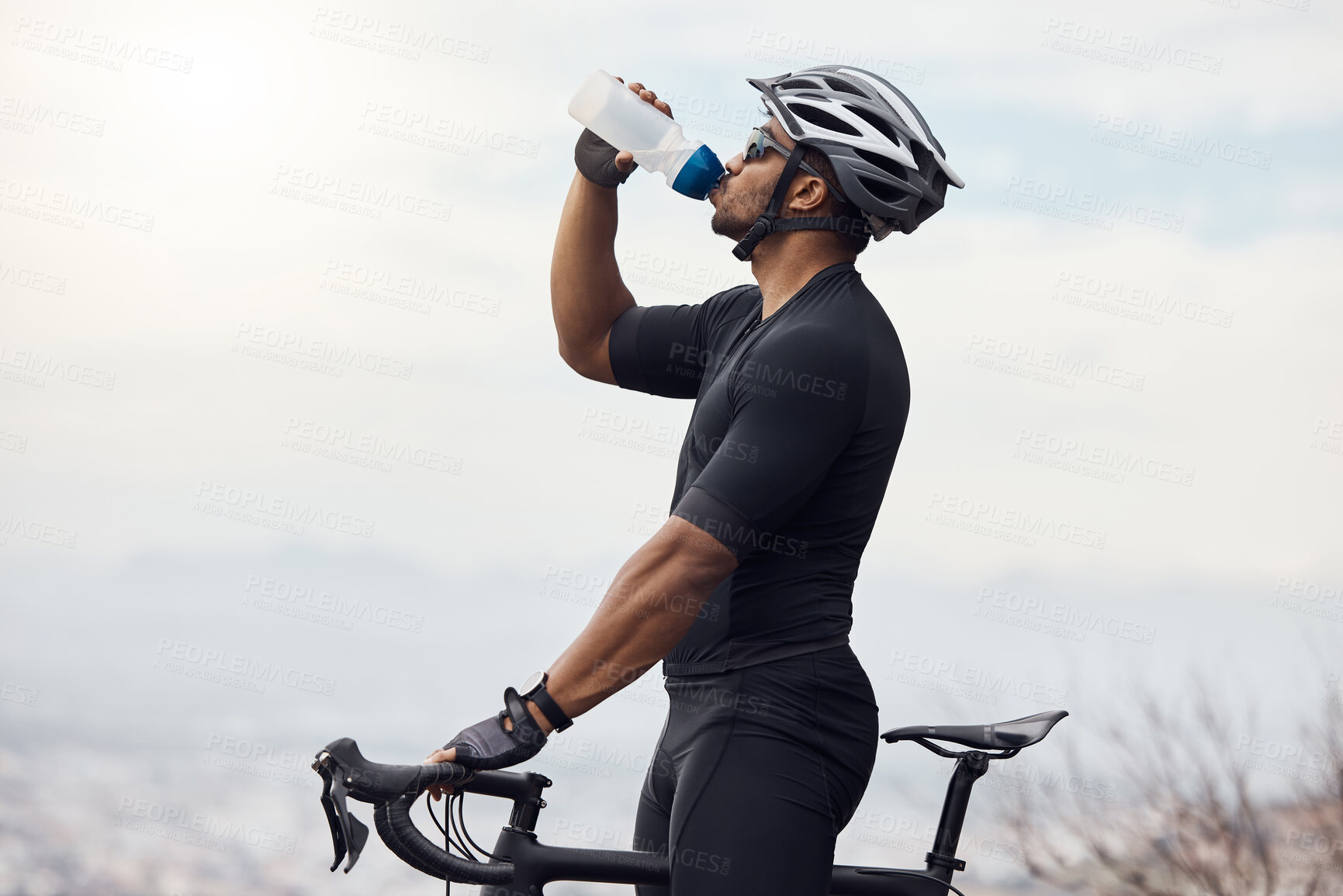 Buy stock photo Sports man with a bike drinking water bottle doing fitness training or workout on sky mockup background. Healthy, professional athlete cyclist with a bicycle during cycling cardio exercise in nature