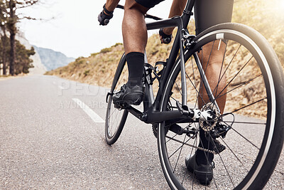Buy stock photo Closeup of unknown indian man cycling on a bike on the road outside during his workout. Fit and active mixed race athlete training and staying healthy through cardio exercise. Getting ready for sports