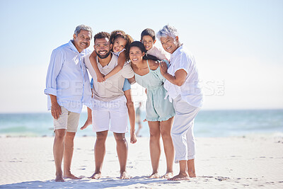 Three generation family on vacation standing together at the beach. Mixed race family with two children, two parents and grandparents spending time together by the sea