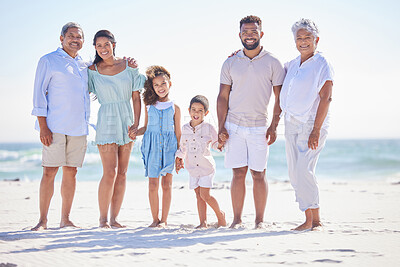 Buy stock photo Multi generation family on holding hands while standing on the beach together. Mixed race family with two children, two parents and grandparents spending time together by the sea