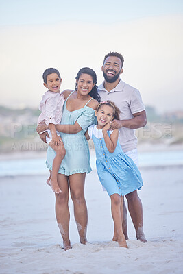 Buy stock photo Full length portrait of a happy mixed race family standing together on the beach. Loving parents spending time with their two children during family vacation by the beach