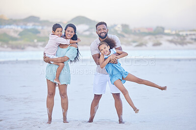Buy stock photo Full length portrait of a happy mixed race family standing together on the beach. Loving parents having fun with their two children during family vacation by the beach