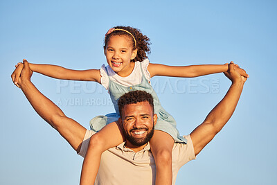 Buy stock photo Happy loving father carrying his daughter on his shoulders while holding hands against blue sky. Adorable little girl on holiday with dad and enjoying family time