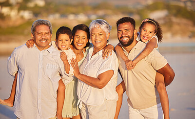 Buy stock photo Portrait of a multi generation family on vacation standing together at the beach on a sunny day. Mixed race family with two children, two parents and grandparents spending time together