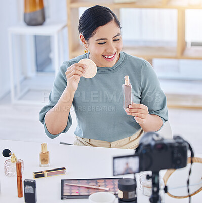 happy young beauty influencer vlogging on her digital camera, making a video applying beauty products to her face using a cotton pad. Smiling young woman applying cosmetic makeup to her skin at home