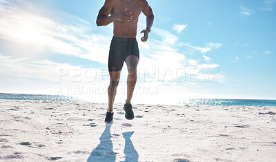 Buy stock photo Fit young black man running and jogging at the beach in the morning while exercising. Closeup of one strong muscular male athlete with six pack abs doing cardio workout to build muscle and endurance