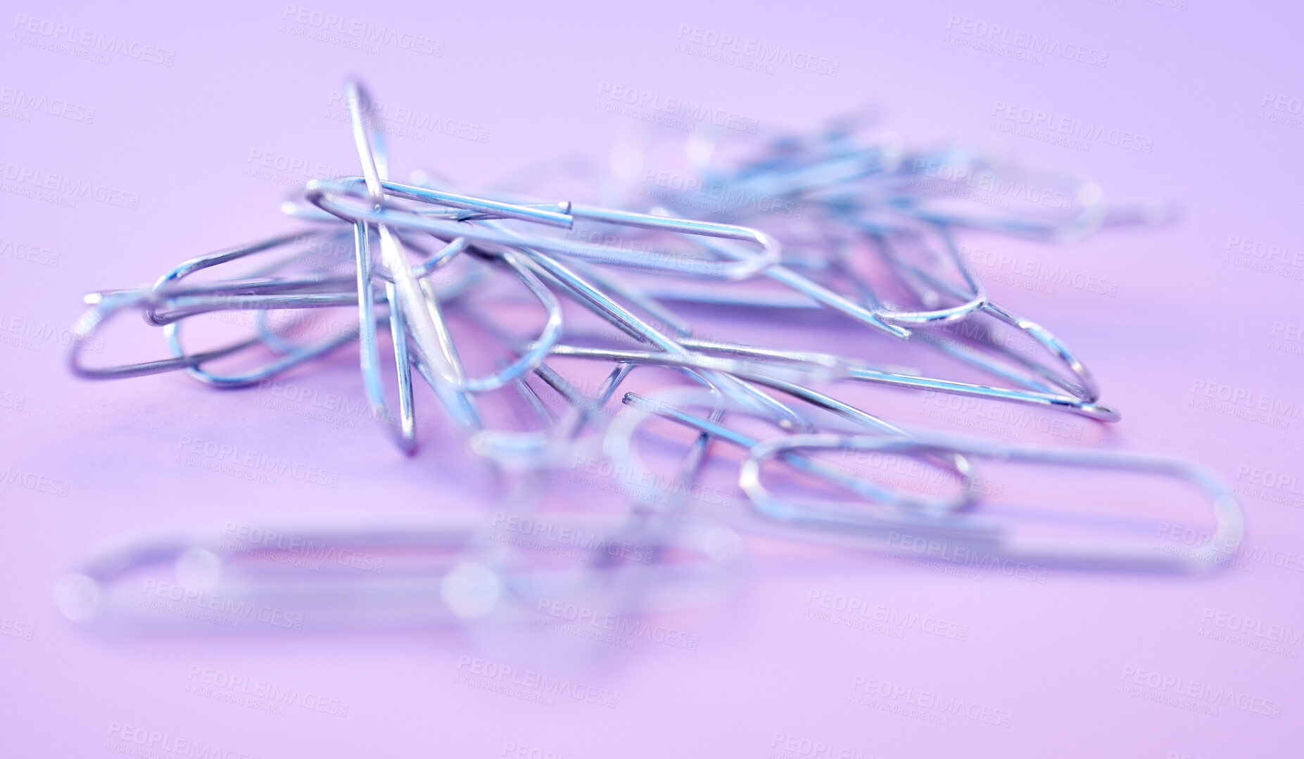 Buy stock photo Paper clips together in pile, connected and a chain on purple background. Office supplies, organization and project management with paperclip for business strategy and planning to organize paperwork.