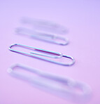 paperclip on the mirror purple background