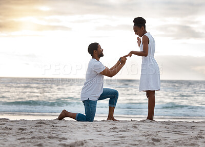 Buy stock photo Love, beach and black couple with proposal, commitment and sunset with happiness, romance and holiday. Romantic, man or woman with engagement ring, asking and question with seaside vacation and smile