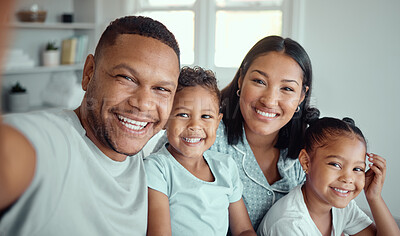 Buy stock photo Photo of a cheerful father holding phone and taking selfie or recording funny video with his family. Happy mixed race family with two children and parents posing together for a family picture on a mobile phone