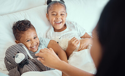 Buy stock photo Happy little sibling brother and sister lying comfortable in bed while mother tucks them in or wake them up in the morning