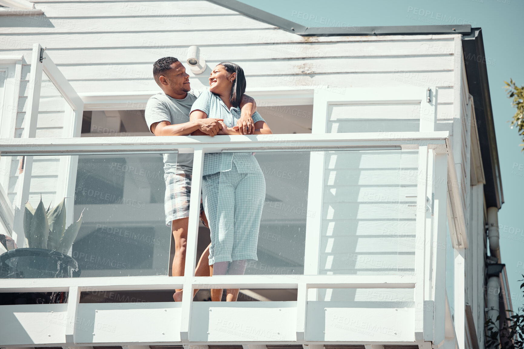 Buy stock photo People, couple and home in balcony with smile for love, support and bonding in morning. Relationship, house and happy or satisfied on patio for break, relax and romance with affection for care