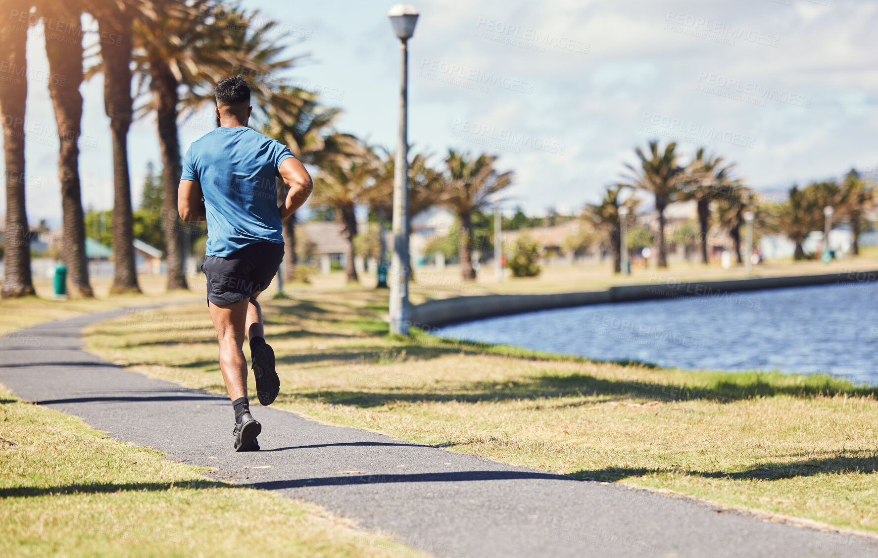 Buy stock photo Fitness, running and a man outdoor for exercise, training or cardio health at a park. Back of male athlete on path by nature canal for morning workout, run and performance goals or healthy lifestyle