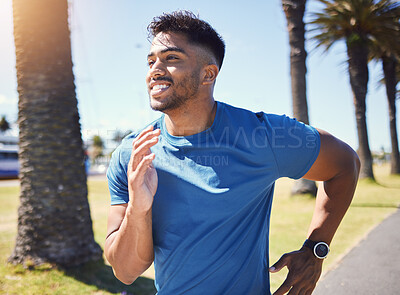 Buy stock photo Fitness, running and man outdoor at park for exercise, training or cardio health. Happy Indian male athlete or runner in nature for a workout, run or jog while thinking of goals or performance