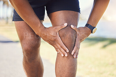 Buy stock photo Closeup of unknown fit active mixed race man holding his knee in pain. Unrecognizable athlete suffering from discomfort from a bad knee injury. Arthritis causing him to hold his leg while exercising 