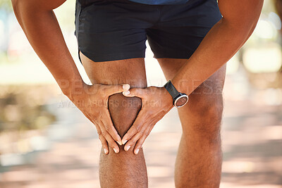 Buy stock photo Closeup of unknown fit active mixed race man holding his knee in pain. Unrecognizable athlete suffering from discomfort from a bad knee injury. Arthritis causing him to hold his leg while exercising