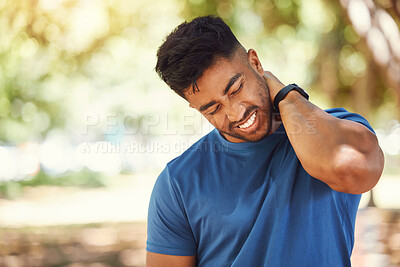Buy stock photo Closeup of young athletic mixed race sportsman holding his neck in pain while suffering from a sports injury. Fit young man touching his neck and experiencing discomfort while exercising outdoors