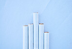 Five different length cigarettes lined up against a blue background in studio. Nicotine addiction can have a variety of levels depending on how much you smoke. The tobacco industry is market dependant