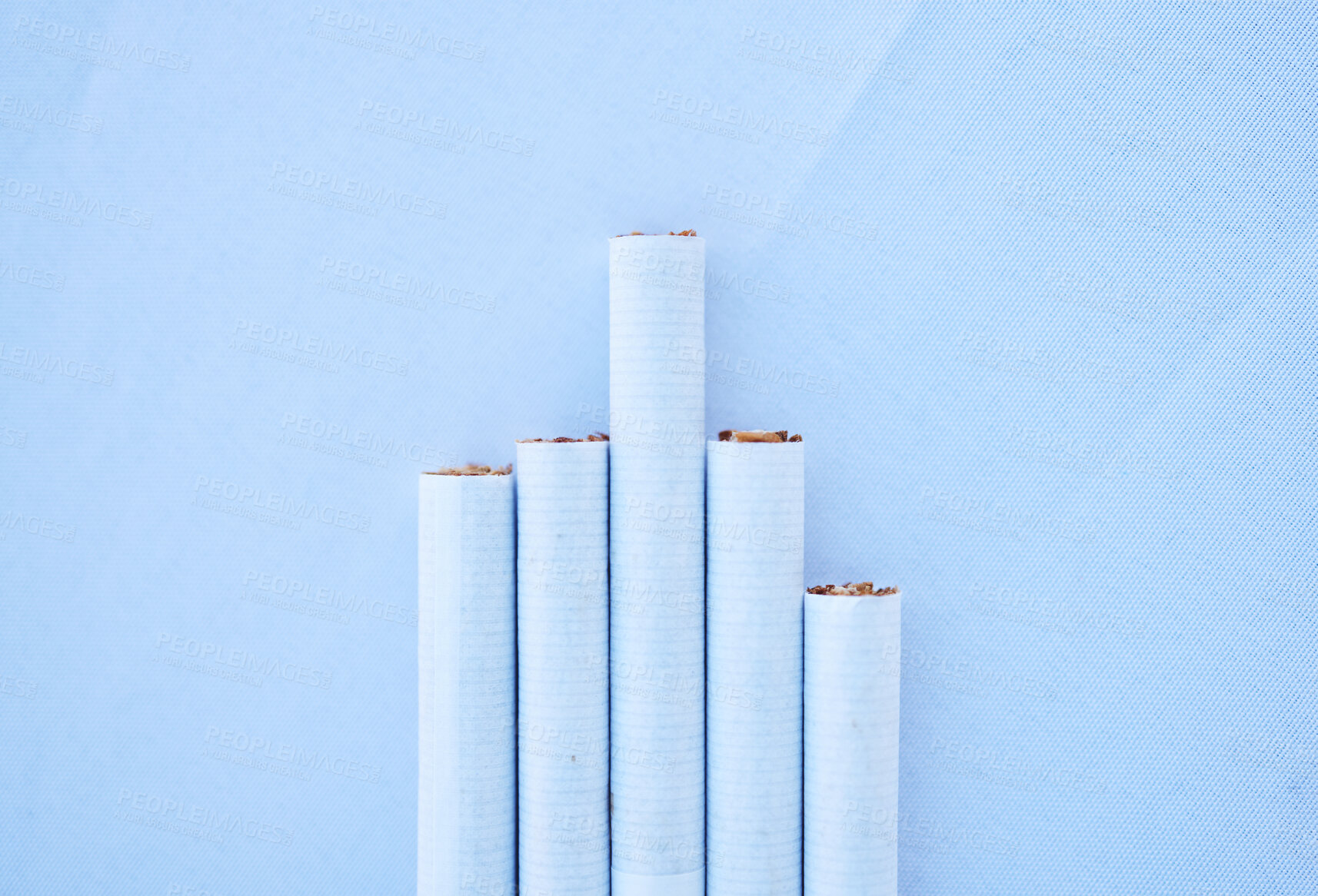 Buy stock photo Cigarettes, table and mockup for healthcare habit, drug danger and lung cancer disease awareness on blue background. Zoom, tobacco smoke product and pack of smoking wellness safety on mock up texture