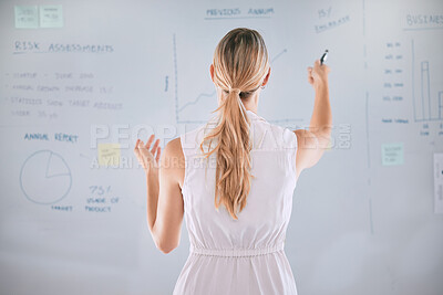 Buy stock photo One caucasian businesswoman from behind brainstorming plans with graphs, stats and analytics on a whiteboard. One female only thinking of ideas and strategies while doing market research for startup