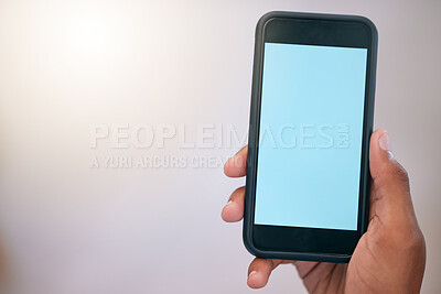 Buy stock photo Unrecognizable person holding and using a phone in their hand at work. One nrecognizable person showing their phone screen and using social media alone