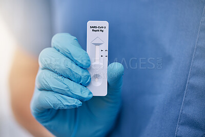 Buy stock photo Unrecognizable doctor holding a rapid covid test while working at a hospital. One unrecognizable doctor wearing a glove and showing and holding a covid test while at work at a clinic