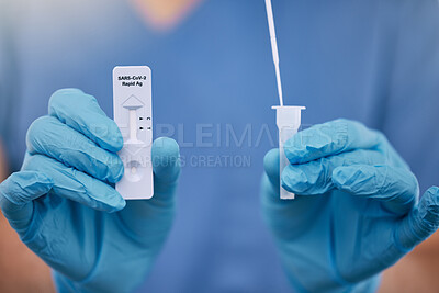 Buy stock photo Unrecognizable doctor holding a covid test and a cotton swab while working alone at a hospital. One unrecognizable nurse working with a cotton swab and covid test at a clinic 