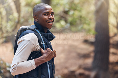 Buy stock photo One young handsome african american male backpacker hiking outdoors in the woods. Confident and happy black man walking through the forest, sightseeing and enjoying his favourite weekend activity