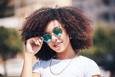 Buy stock photo Woman, fashion and sunglasses on face outdoor in city for summer holiday and travel with a smile. Portrait of African person with natural hair or afro and trendy glasses at a park for freedom