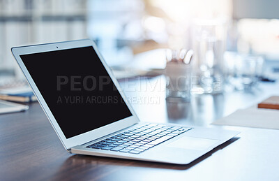 Buy stock photo Closeup of a laptop with a blank black screen on a wooden desk in an empty office. Macro view of technology in a creative or corporate workspace. Staying connected for online business and networking