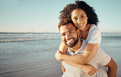 Buy stock photo Piggyback, happy and portrait of couple at beach for summer holiday, vacation and romantic date. Love, dating and mixed race man and woman enjoying sunset for bonding, relaxing and honeymoon by sea