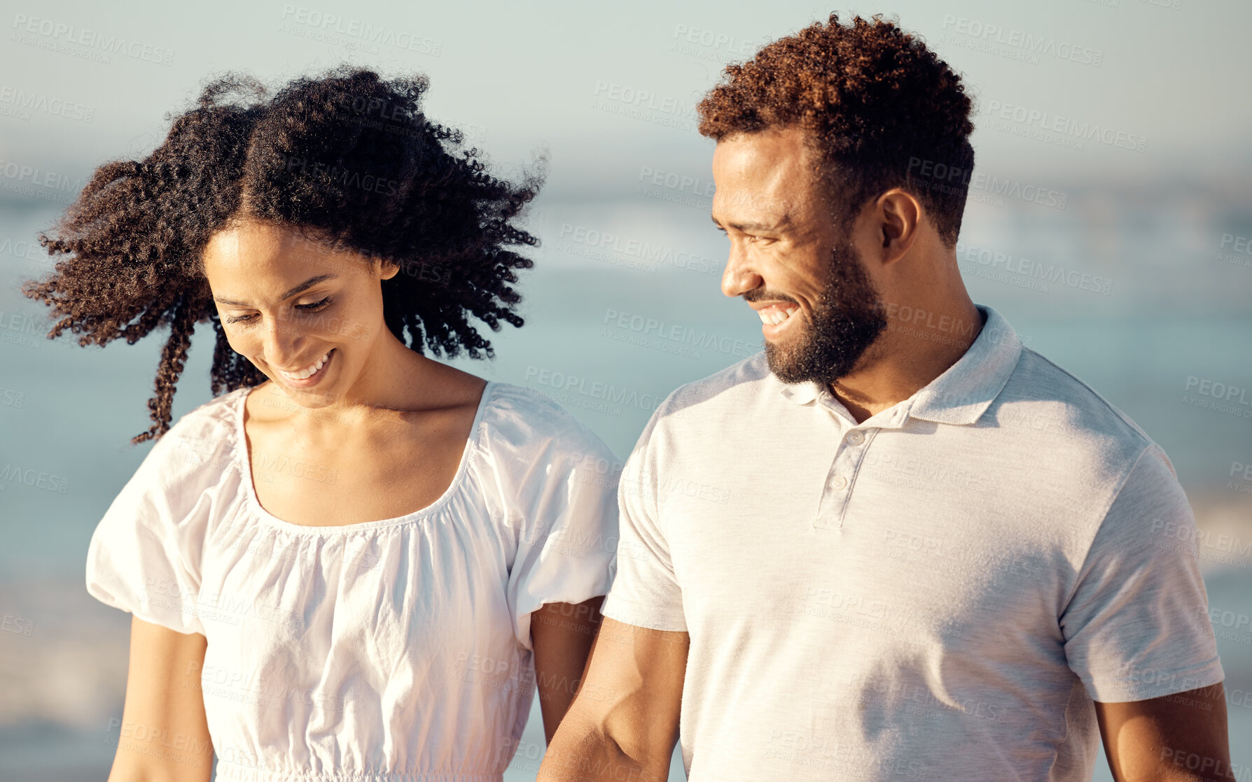 Buy stock photo Walking, travel and couple with smile at beach for summer holiday, vacation and romantic date. Love, dating and mixed race man and woman enjoying sunset for bonding, relaxing and honeymoon by sea