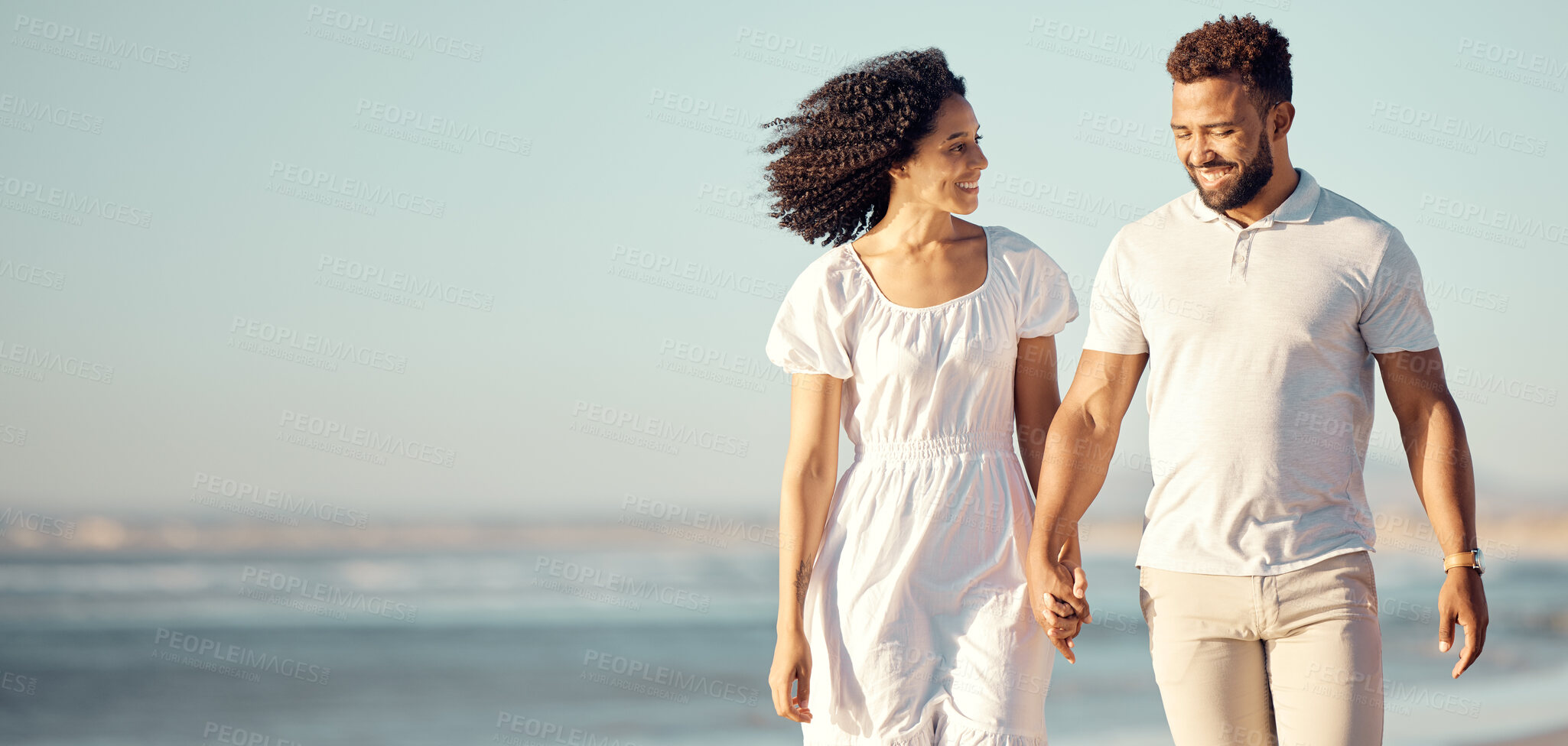 Buy stock photo Walking, travel and couple holding hands at beach for summer holiday, vacation and romantic date. Love, dating and mixed race man and woman enjoying sunset for bonding, relaxing and honeymoon by sea