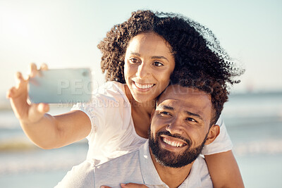 Buy stock photo Couple, piggyback and selfie at beach, summer sunshine and happy for travel, blog and post on web. Man, woman and smile for photography on romantic vacation, profile picture and social network app
