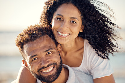 Buy stock photo Closeup portrait of an young affectionate mixed race couple standing on the beach and smiling during sunset outdoors. Hispanic couple showing love and affection on a romantic date at the beach