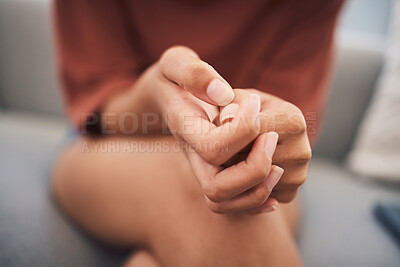Closeup shot of a mixed race woman hands suffering mental breakdown. Young domestic violence victim afraid and suffering depression and anxiety in a safe house for abused victims of gender violence