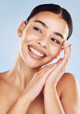 Closeup face beautiful young mixed race woman. An attractive female posing in studio isolated against a blue background. A skincare regime that keeps your skin soft, smooth, glowing and healthy