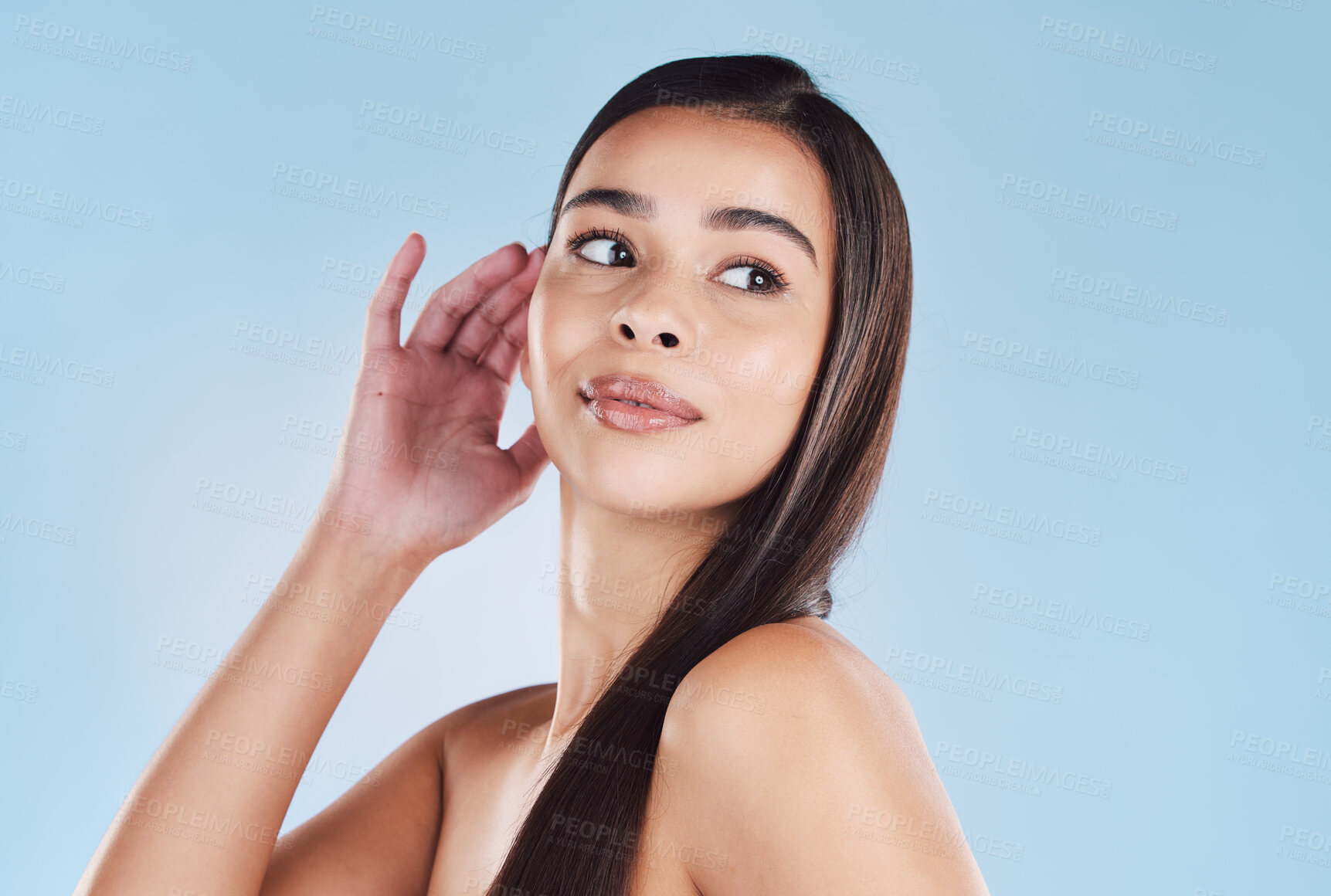 Buy stock photo One beautiful young hispanic woman with healthy skin and sleek long hair posing against a blue studio background. Mixed race model with flawless complexion and natural beauty