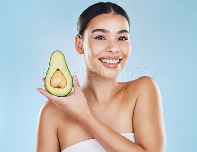 Buy stock photo Skincare, health and avocado with a woman portrait on studio blue background and mockup. Young model with healthy fruit nutrition for face, skin care ingredients and clean, perfect or natural results