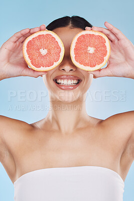 Buy stock photo Grapefruit for skincare, beauty cosmetic and healthy product with nutrition for face against blue mockup studio background. Natural dental wellness, fruit for clean body and smile by happy model